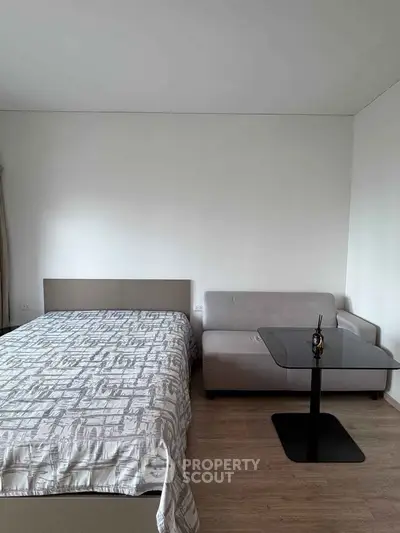 Modern bedroom with stylish decor and cozy seating area