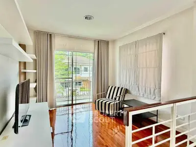 Bright and airy living room with modern decor and large window view.