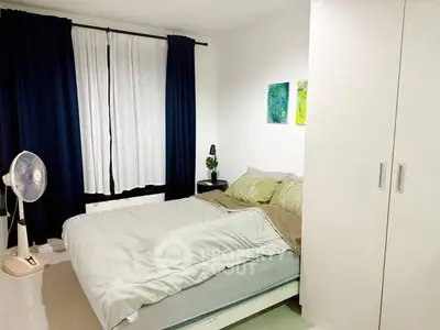 Cozy bedroom with modern decor and ample natural light