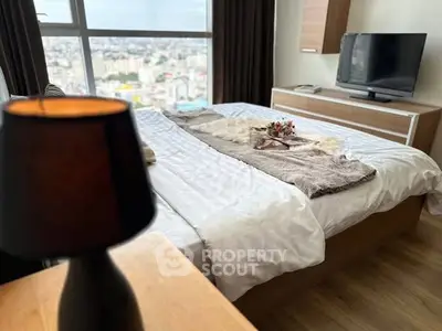 Cozy bedroom with city view, modern furnishings, and ambient lighting.