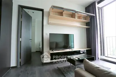 Modern living room with sleek TV setup and balcony view