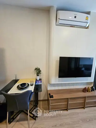 Modern living room with wall-mounted TV and stylish dining area