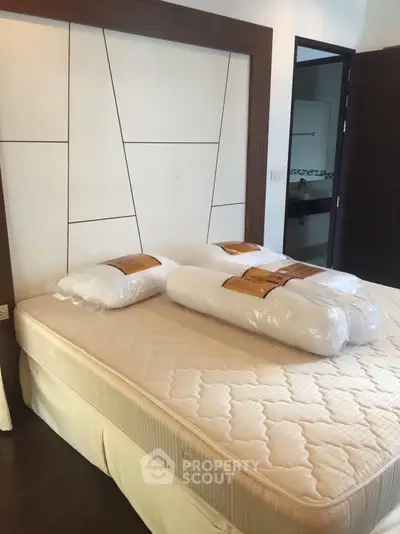 Spacious bedroom with modern design and comfortable bedding in a stylish apartment.