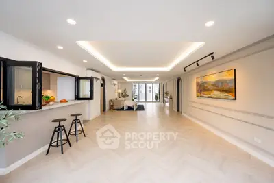 Spacious open-plan living room with modern decor and stylish lighting