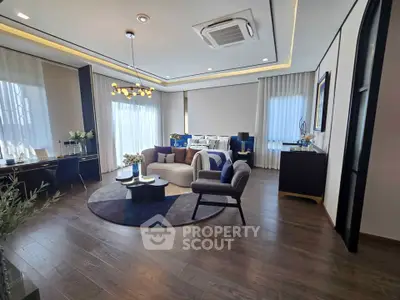 Luxurious modern living room with elegant decor and ample natural light.