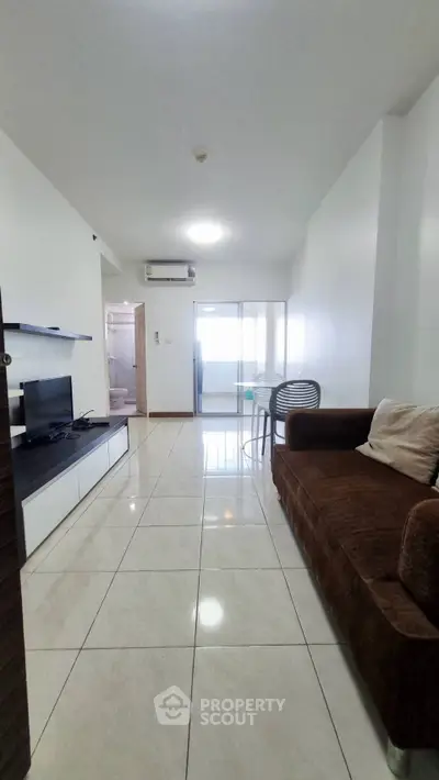 Spacious living room with modern decor and balcony access