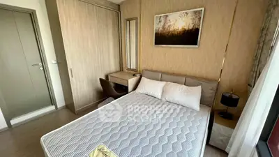 Modern bedroom with stylish decor and natural light, featuring a cozy bed and elegant furnishings.