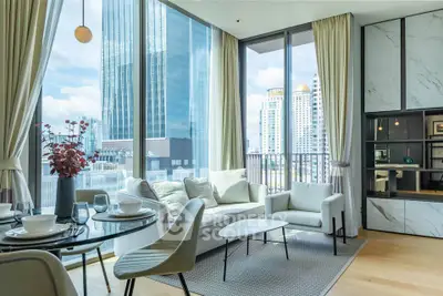 Luxurious modern living room with floor-to-ceiling windows offering stunning city views, elegant decor, and cozy seating.