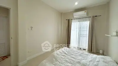 Cozy bedroom with natural light and air conditioning in modern apartment