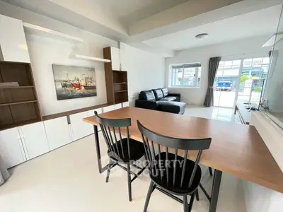 Spacious modern living room with sleek furniture and large windows for natural light.