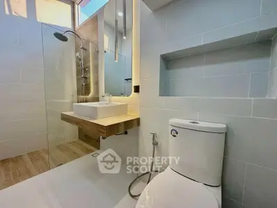 Modern bathroom with sleek fixtures and glass shower enclosure