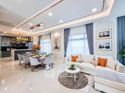 Luxurious open-plan living and dining area with elegant decor and modern lighting.