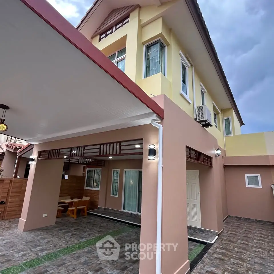 Stunning two-story home with modern exterior and spacious carport, perfect for family living.