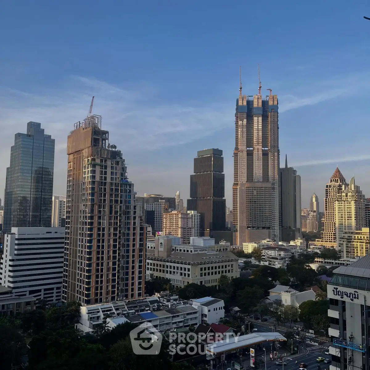 Stunning cityscape view with modern skyscrapers and lush greenery, perfect for urban living.