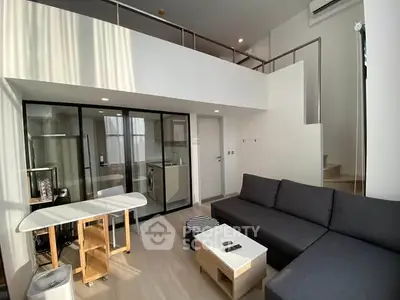 Modern loft-style living room with mezzanine and sleek design