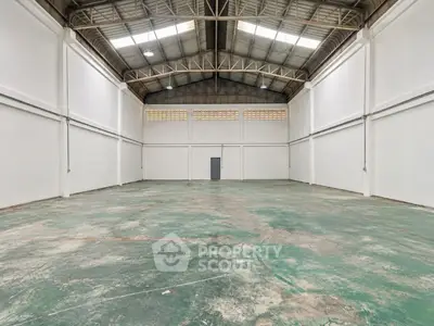 Spacious industrial warehouse with high ceilings and ample floor space.