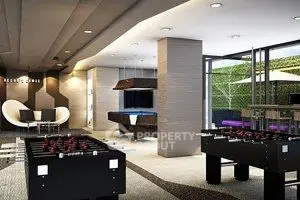 Luxurious game room with foosball tables and modern seating area