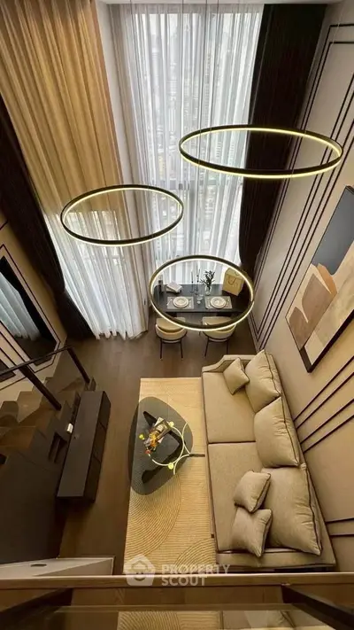 Luxurious modern living room with high ceilings and elegant lighting fixtures