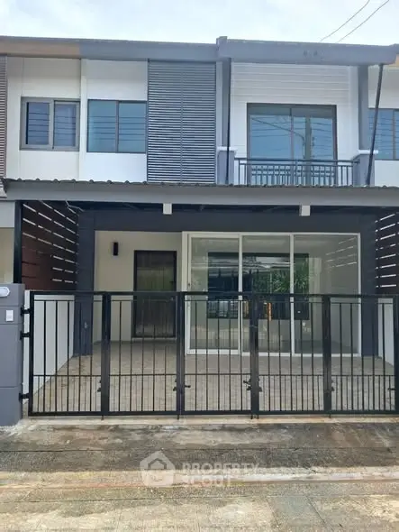 Modern townhouse exterior with sleek design and gated entrance