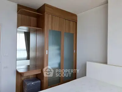 Modern bedroom with sleek wooden wardrobe and natural light
