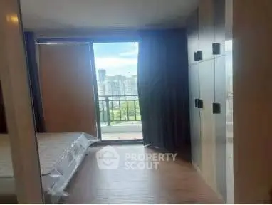 Spacious bedroom with balcony offering stunning city view