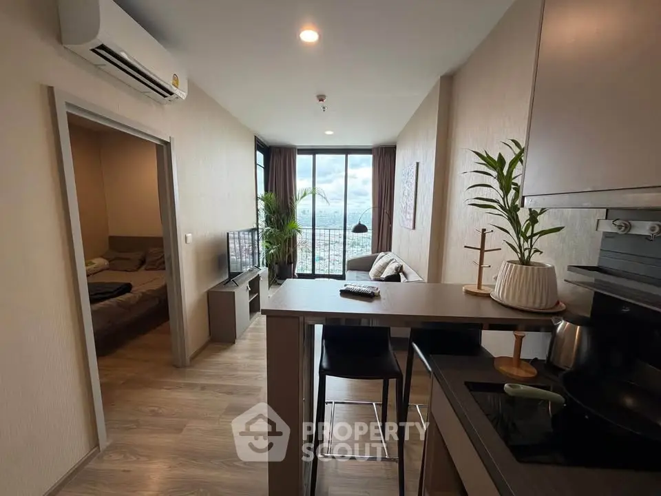 Modern apartment interior with open kitchen and stunning city view