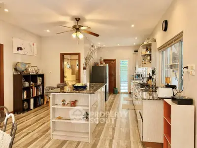 Spacious kitchen with modern appliances and open layout, featuring a central island and stylish decor.