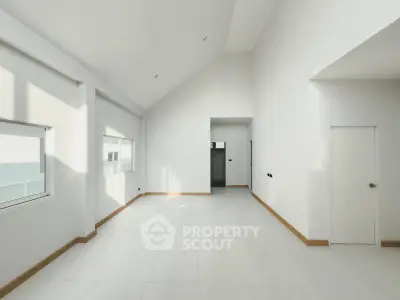 Spacious minimalist interior with high ceilings and natural light