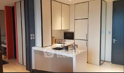 Modern kitchen with sleek cabinetry and integrated appliances in a stylish apartment.