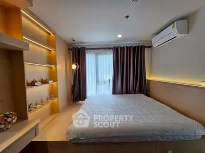 Modern bedroom with stylish lighting and large window for natural light