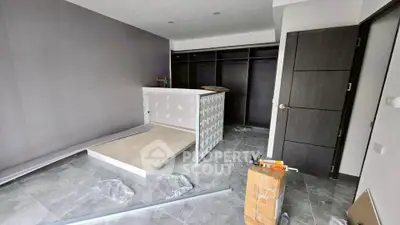 Spacious bedroom under renovation with modern design and ample closet space.