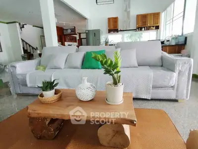 Spacious living room with stylish sofa and rustic wooden coffee table