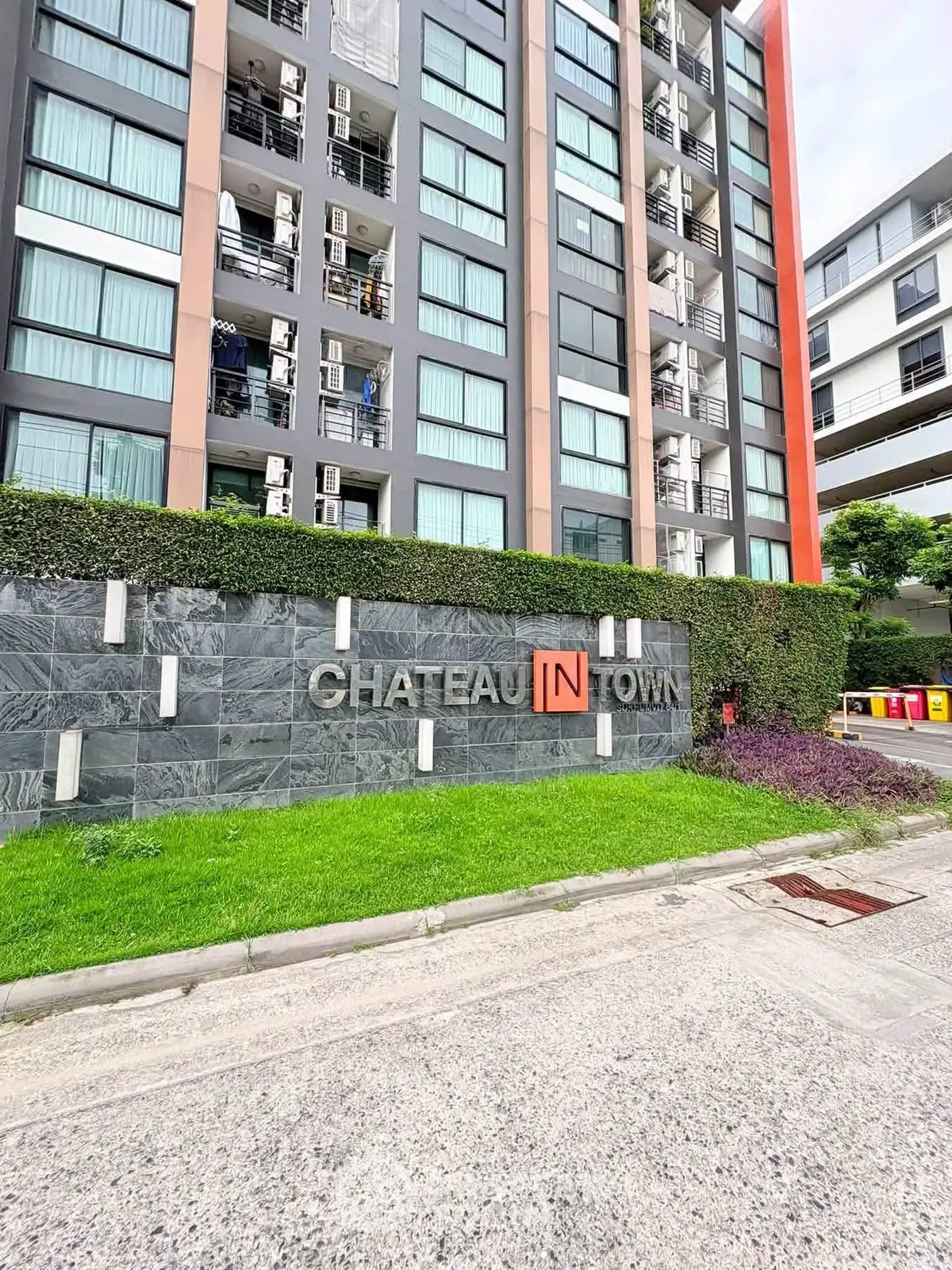 Modern condominium exterior with lush greenery at Chateau In Town.