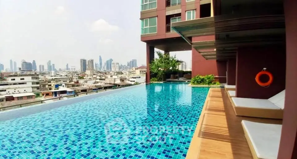 Luxurious rooftop pool with stunning city skyline view in modern apartment complex.