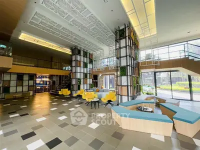 Spacious modern lobby with stylish seating and large windows offering garden views.