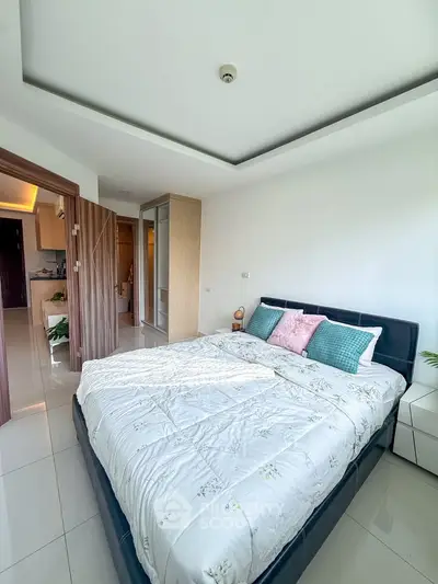Spacious bedroom with modern decor and ample natural light in a stylish apartment.