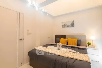 Cozy modern bedroom with stylish decor and ambient lighting
