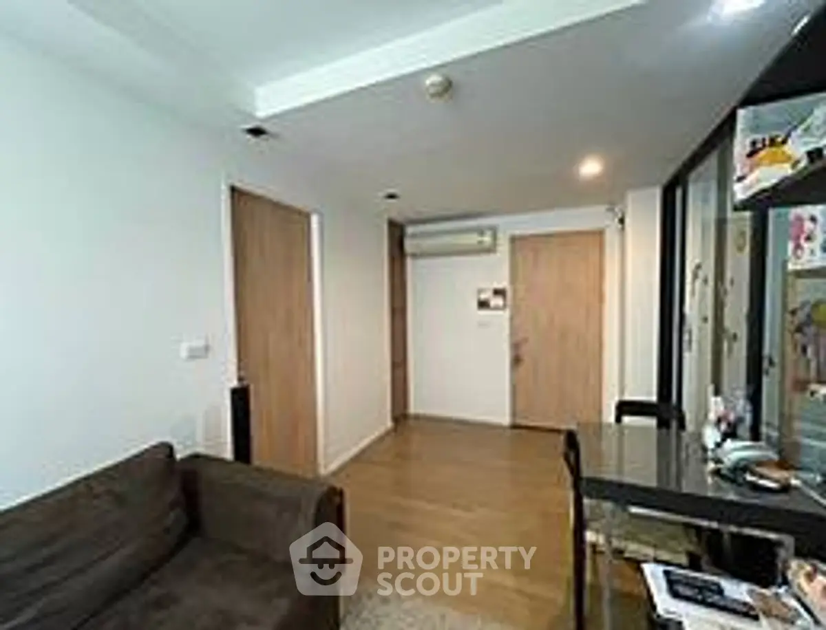 Modern living room with sleek design and wooden accents, featuring a cozy sofa and stylish decor.