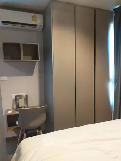 Modern bedroom with sleek wardrobe and compact study area, perfect for urban living.