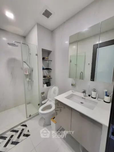Modern bathroom with glass shower and sleek fixtures