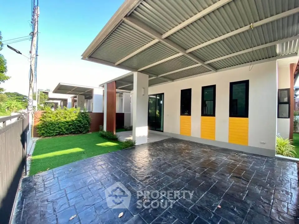 Modern single-story home with spacious carport and lush green lawn