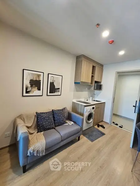 Modern compact living room with integrated kitchen and washing machine