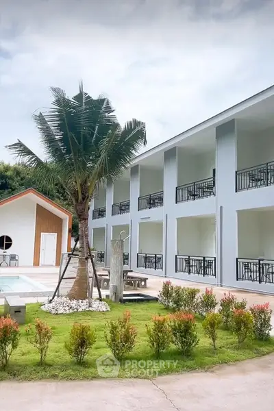 Modern apartment building with balconies and landscaped garden