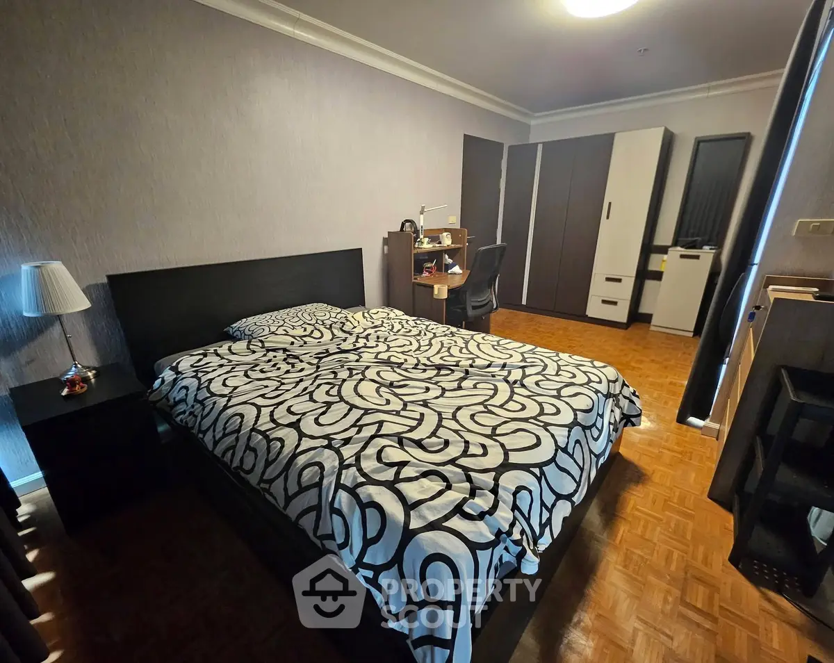 Spacious bedroom with modern decor and ample storage space.