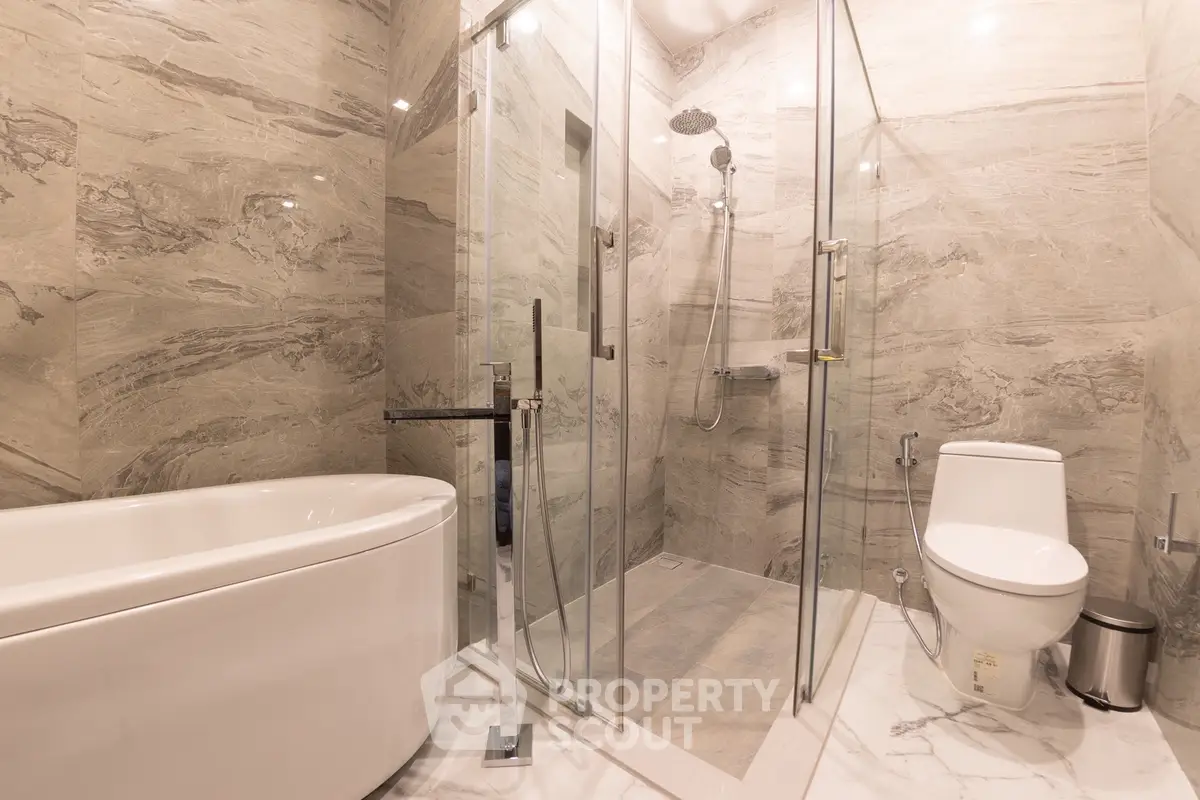 Luxurious modern bathroom with elegant marble tiles and glass shower enclosure