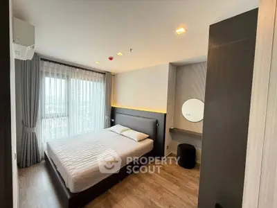 Modern bedroom with large window and stylish decor in high-rise apartment