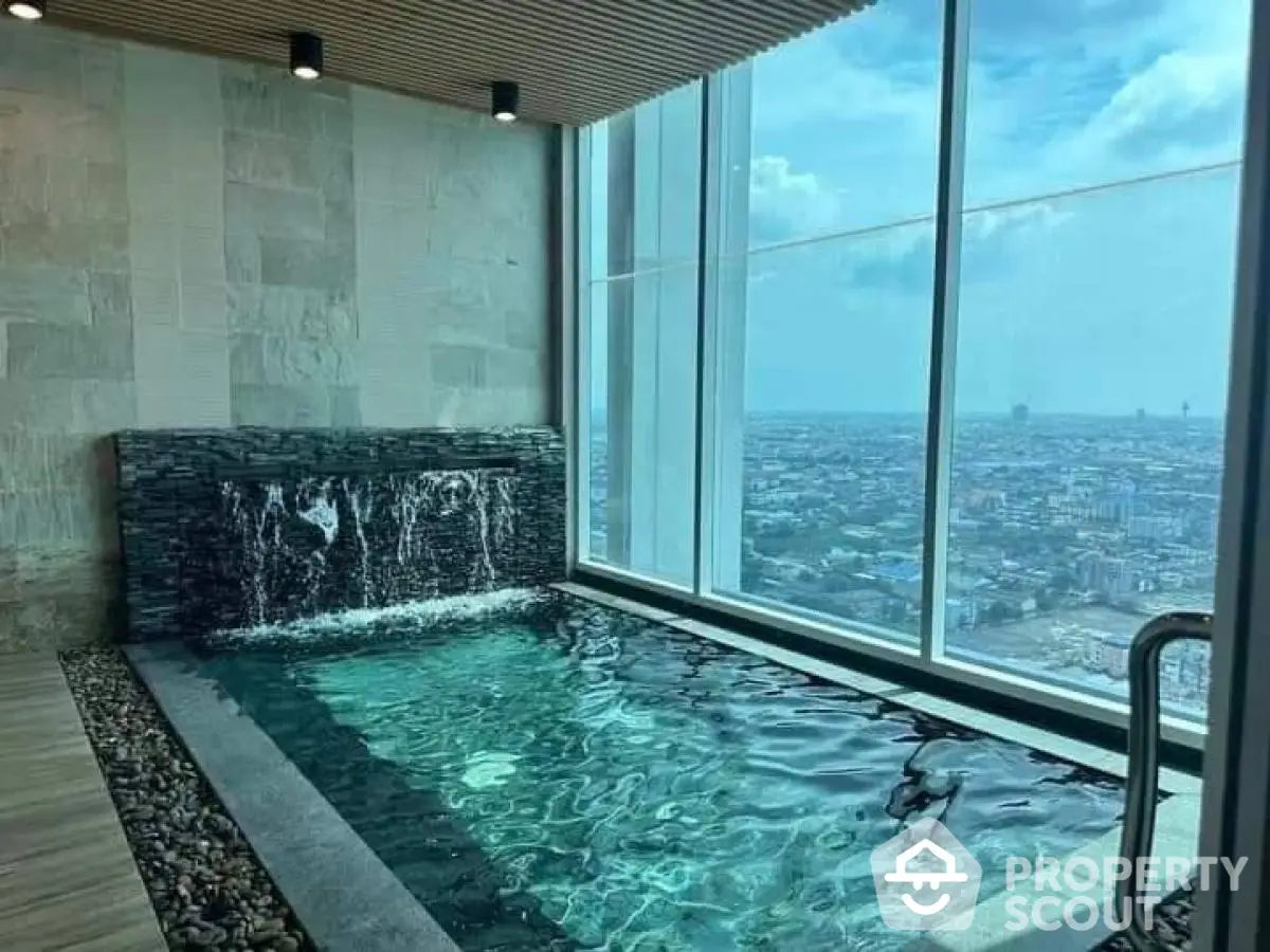 Luxurious indoor pool with stunning city view from high-rise building