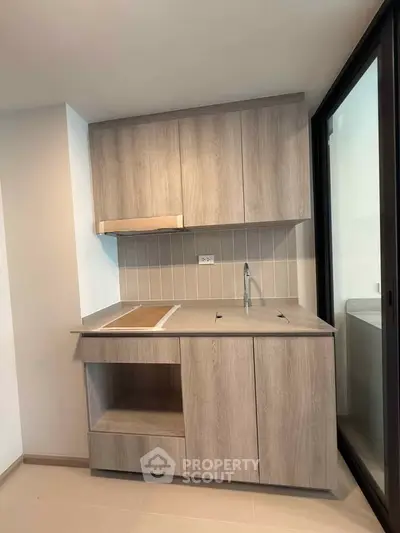 Modern kitchen with sleek wooden cabinets and minimalist design