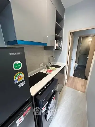 Modern compact kitchen with sleek appliances and efficient layout