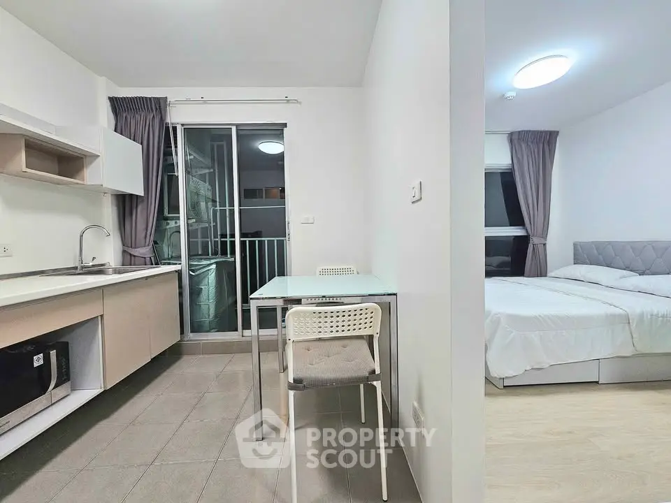 Modern studio apartment with open kitchen and cozy bedroom